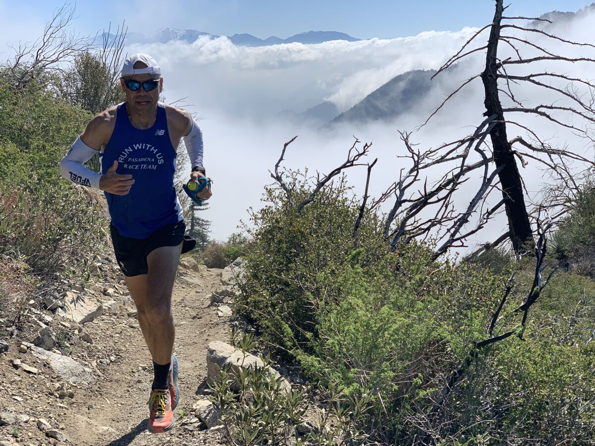 Jerry Garcia runs at the San Gabriel Peak in the Angeles National Forest. In the background is Mt. Wilson.