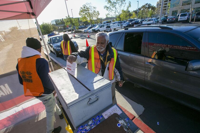 Election workers collected ballots from drive up voters at the main Registrar of Voters office in Kearny Mesa on election day, Tuesday March 3, 2020.