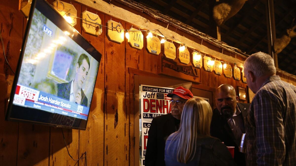 Supporters of U.S. Rep. Jeff Denham (R-Turlock) gather by a TV at an election-night party on Nov. 6 in Modesto, Calif. Denham led in the returns that night, but late tallies tipped the election to Democrat Josh Harder.