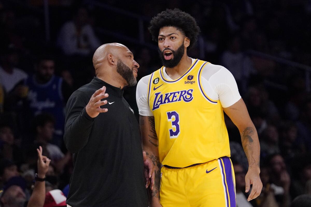 Lakers head coach Darvin Ham, left, talks with forward Anthony Davis.