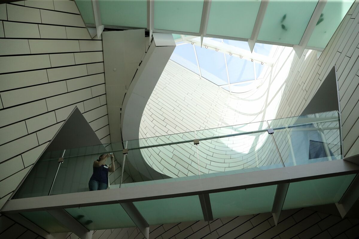 A visitor takes a photograph above the main entrance of the new Orange County Museum of Art in Costa Mesa on Wednesday.