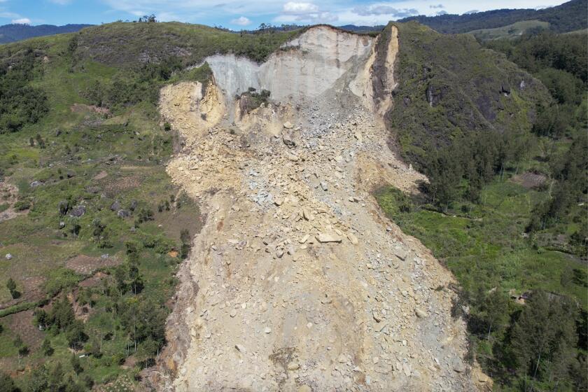 CORRECTS DATE - In this image taken from video, drone footage shows a landslide in Yambali village, in the Highlands of Papua New Guinea, Monday, May 27, 2024. Emergency responders say that up to 8,000 people might need to be evacuated as the mass of boulders, earth and splintered trees that crushed the village of Yambali in the nation's mountainous interior on Friday, May 24 becomes increasingly unstable. (Juho Valta/UNDP Papua New Guinea via AP)
