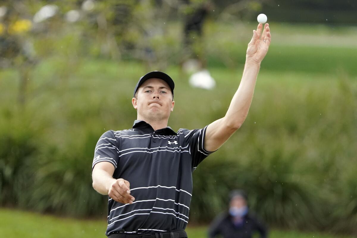 Jordan Spieth tosses his ball to his caddie after making a hole in one on the second hole March 6, 2021.