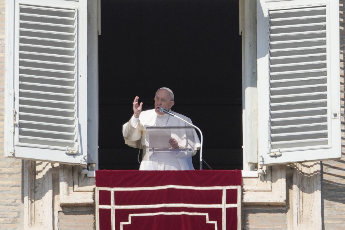 Pope Francis leads a prayer from his studio window