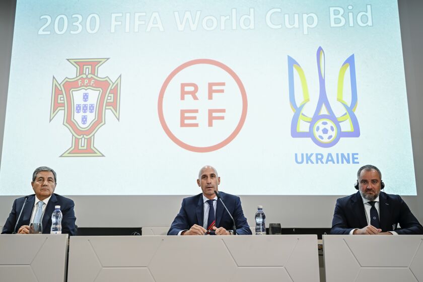 Portuguese Soccer Federation President Fernando Gomes, left, President of the Spanish Royal Federation of Soccer (RFEF), Luis Rubiales, center, Ukrainian Football Federation President Andriy Pavelko, right, speak during a press conference about the announcing that Ukraine is joining Spain and Portugal in their joint bid to host the World Cup in 2030, at the UEFA Headquarters, in Nyon, Switzerland, Wednesday, October 5, 2022. The proposal harnesses the idea that football can restore hope and peace, while Ukraine has been at war with Russia for months.(Martial Trezzini/Keystone via AP)
