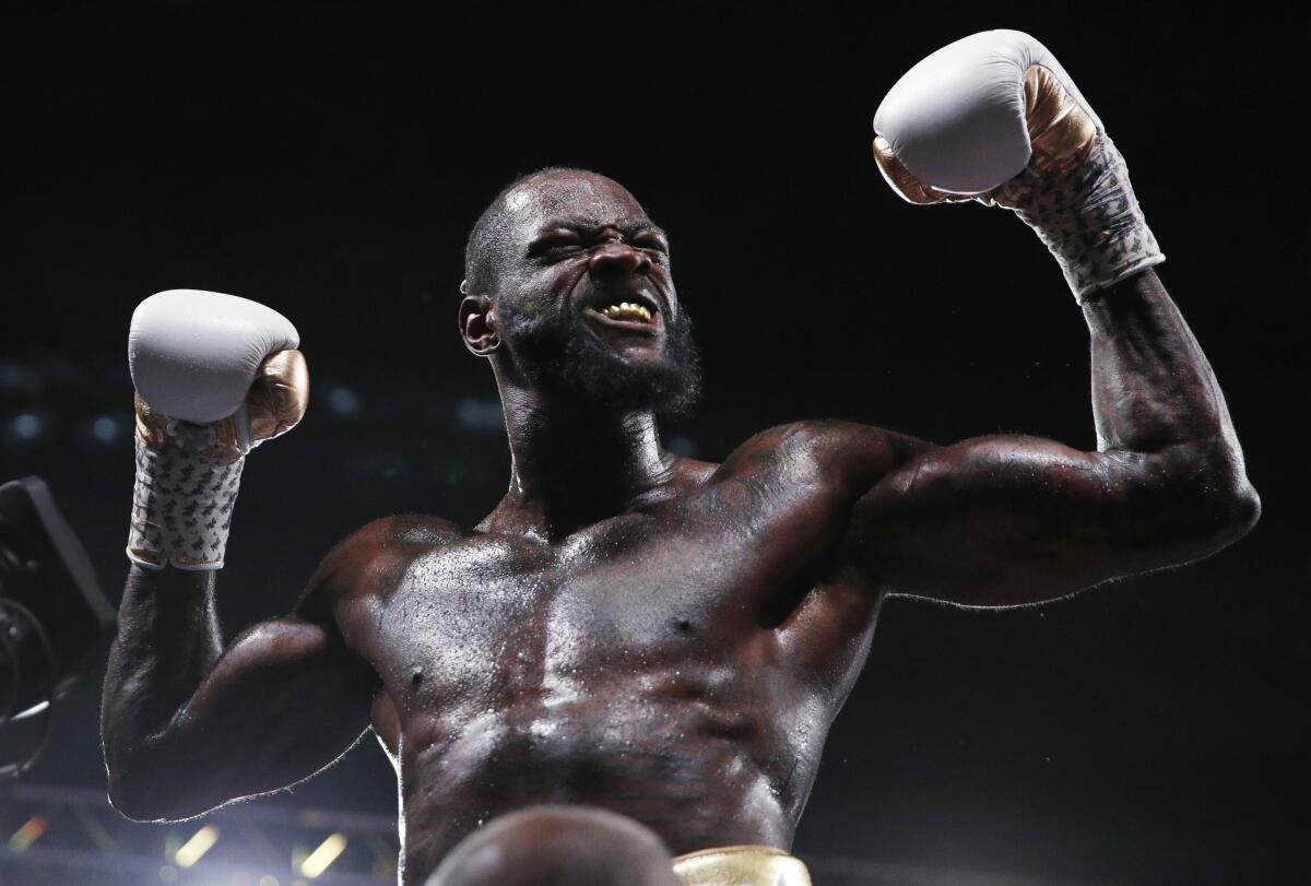Deontay Wilder celebrates after defeating Luis Ortiz in the WBC heavyweight title boxing match on Saturday in Las Vegas.