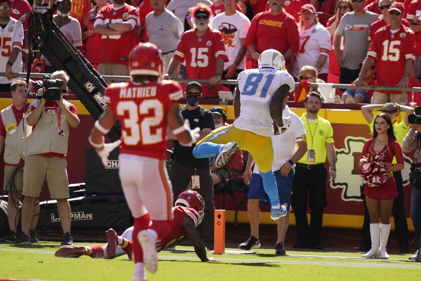 Los Angeles Chargers' Mike Williams (81) makes a touchdown reception during the second half of an NFL football game against the Kansas City Chiefs, Sunday, Sept. 26, 2021, in Kansas City, Mo. Los Angeles won 30-24. (AP Photo/Charlie Riedel)