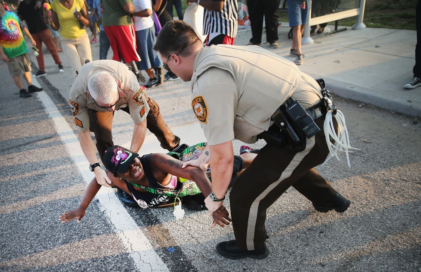 A demonstrator in Ferguson is arrested.