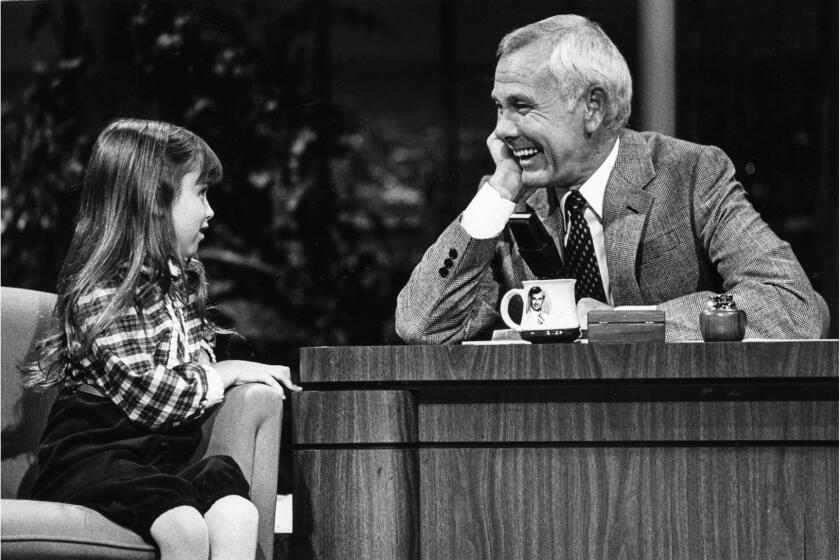 Sep. 15, 1982: Johnny Carson gets a laugh during conversation with 7-year-old actress Kaleena Kiff. This photo appeared in the Sep. 17, 1982, Los Angeles Times.