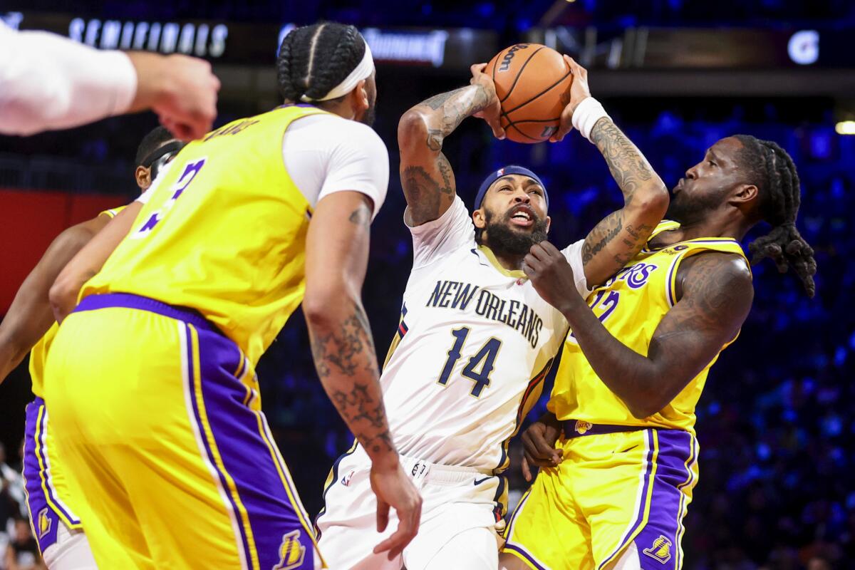 New Orleans Pelicans forward Brandon Ingram, center, drives past Lakers forward Taurean Prince.