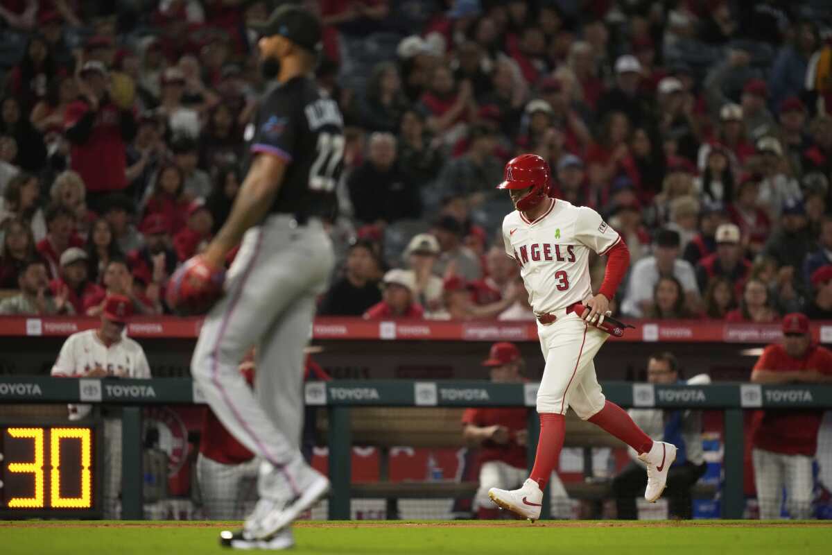 Los Angeles Angels' Taylor Ward, right, scores after Travis d'Arnaud was hit by a pitch.