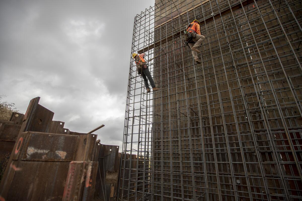 Workers tie rebar on a support structure located on the south end of the Cedar Viaduct section of the California High-Speed Rail project.