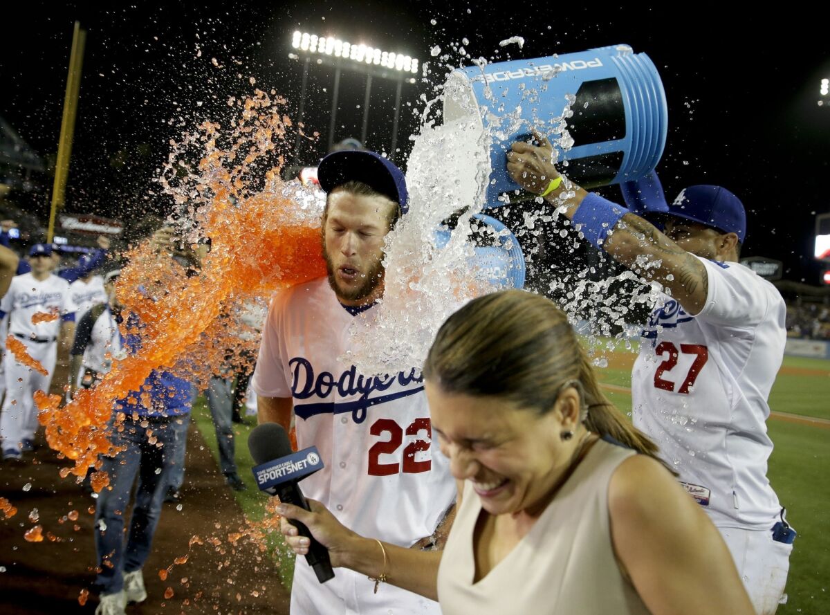 Teammates give Clayton Kershaw a celebratory Gatorade bath as he's interviewed after pitching a no-hitter against the Rockies on Wednesday night at Dodger Stadium.