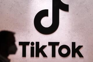 A visitor walks past the TikTok booth at the Gamescom trade fair in Cologne.