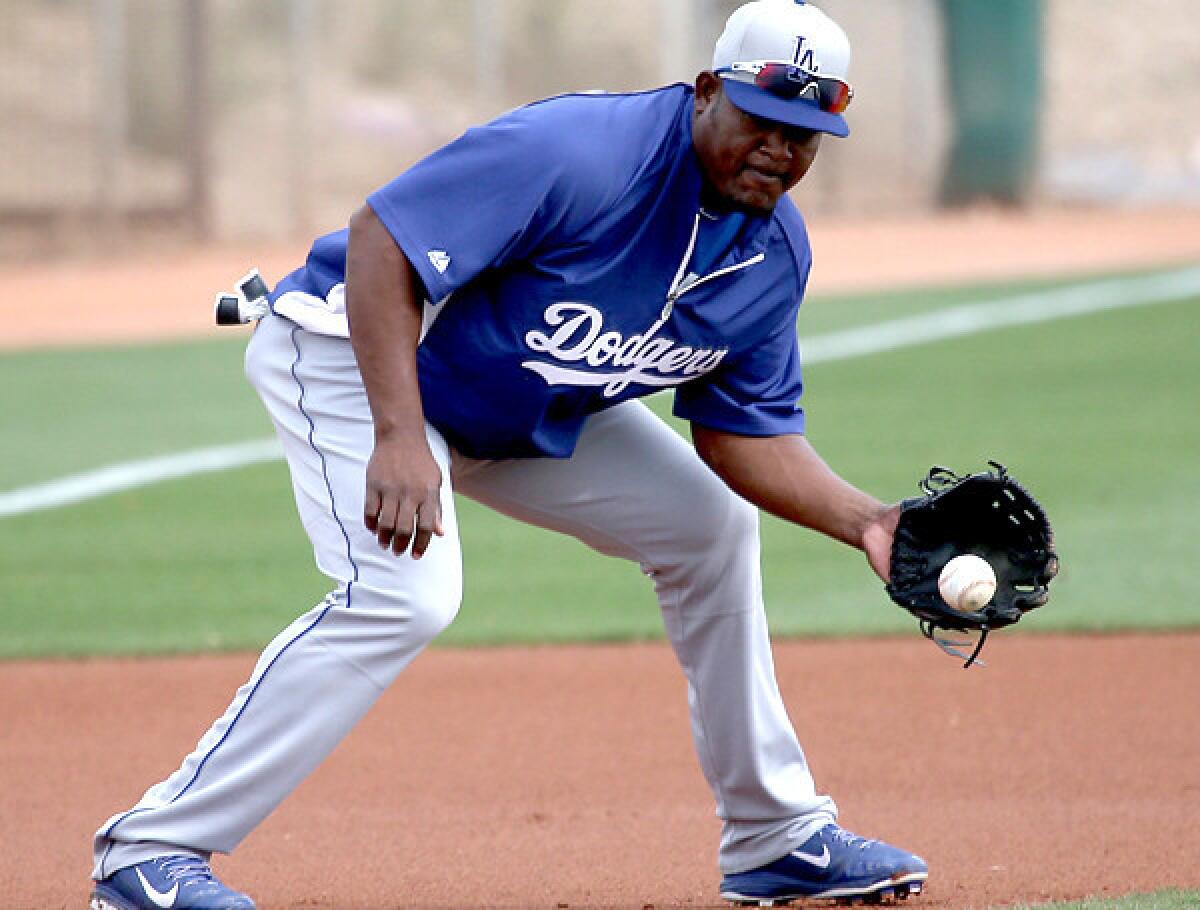 Dodgers third baseman Juan Uribe, who had two hits including a home run Thursday, fields a grounder during a spring training workout on Tuesday.