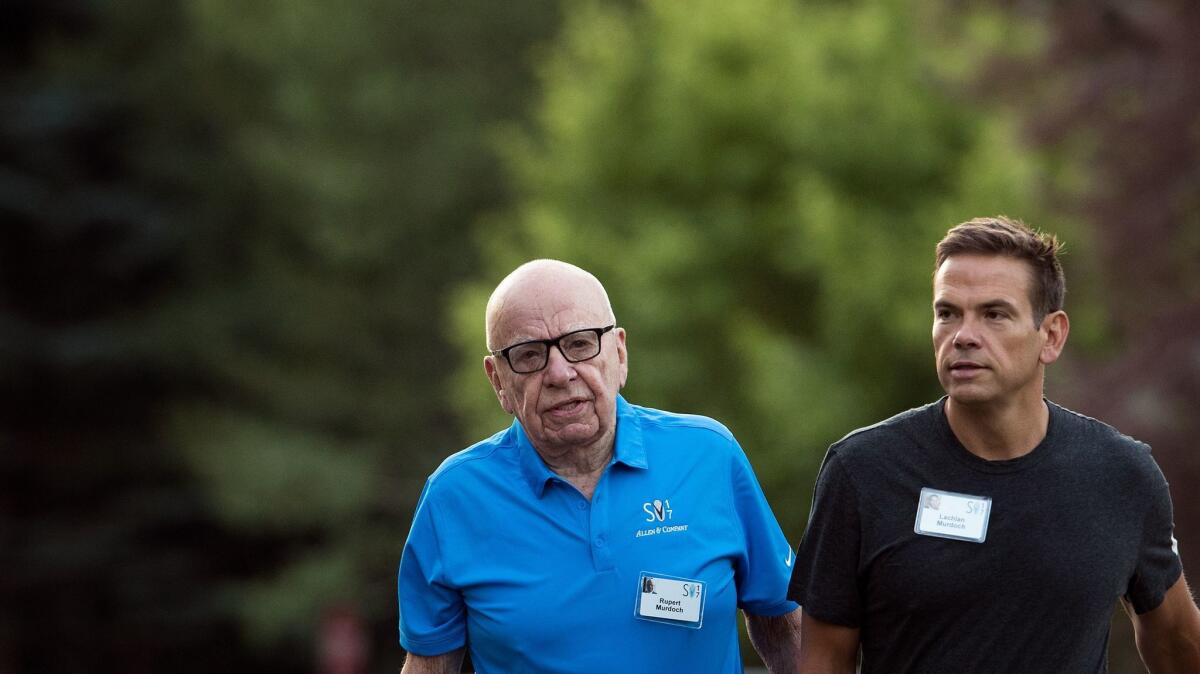 Lachlan Murdoch, right, with his father, Rupert, at the annual Allen & Company Sun Valley Conference in Idaho, wants to release movies to the home sooner.