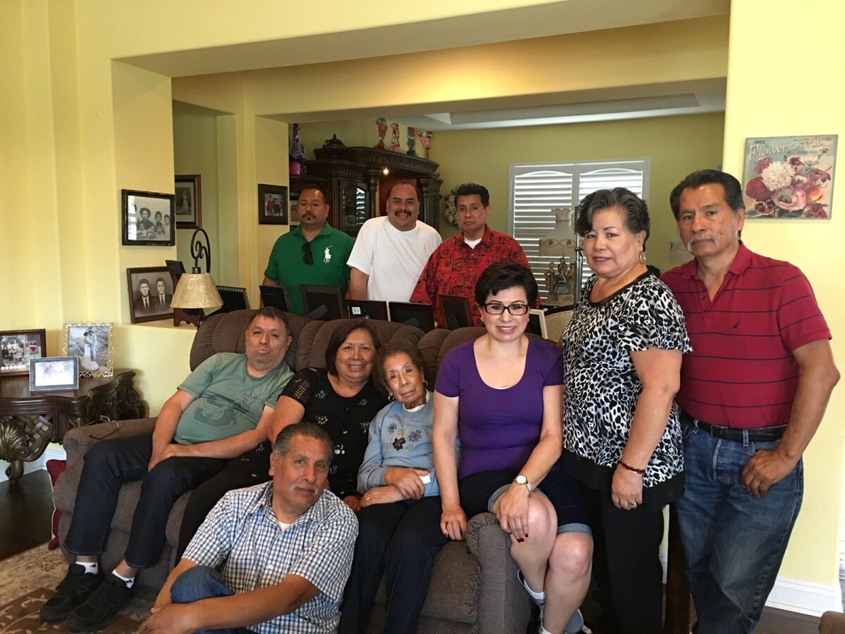 Dolores Robledo with her children, nieces and nephews at her home in Escondido.