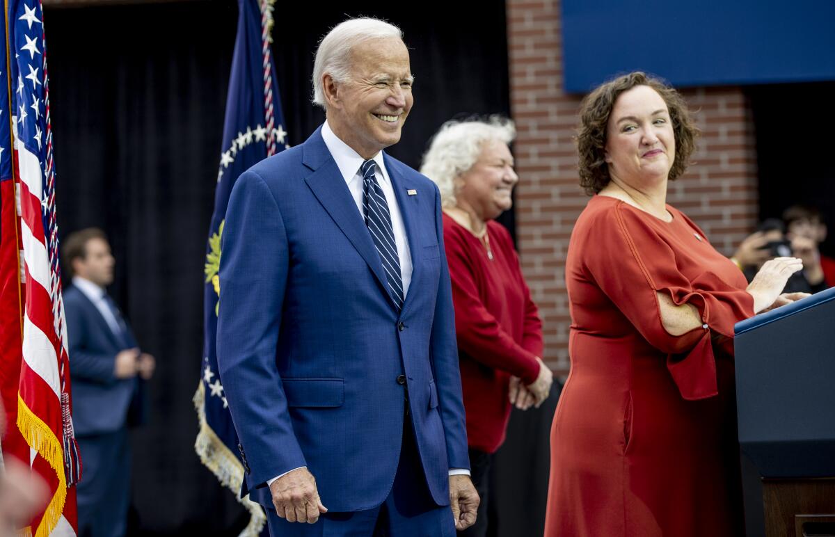President Biden standing near Rep. Katie Porter at an event