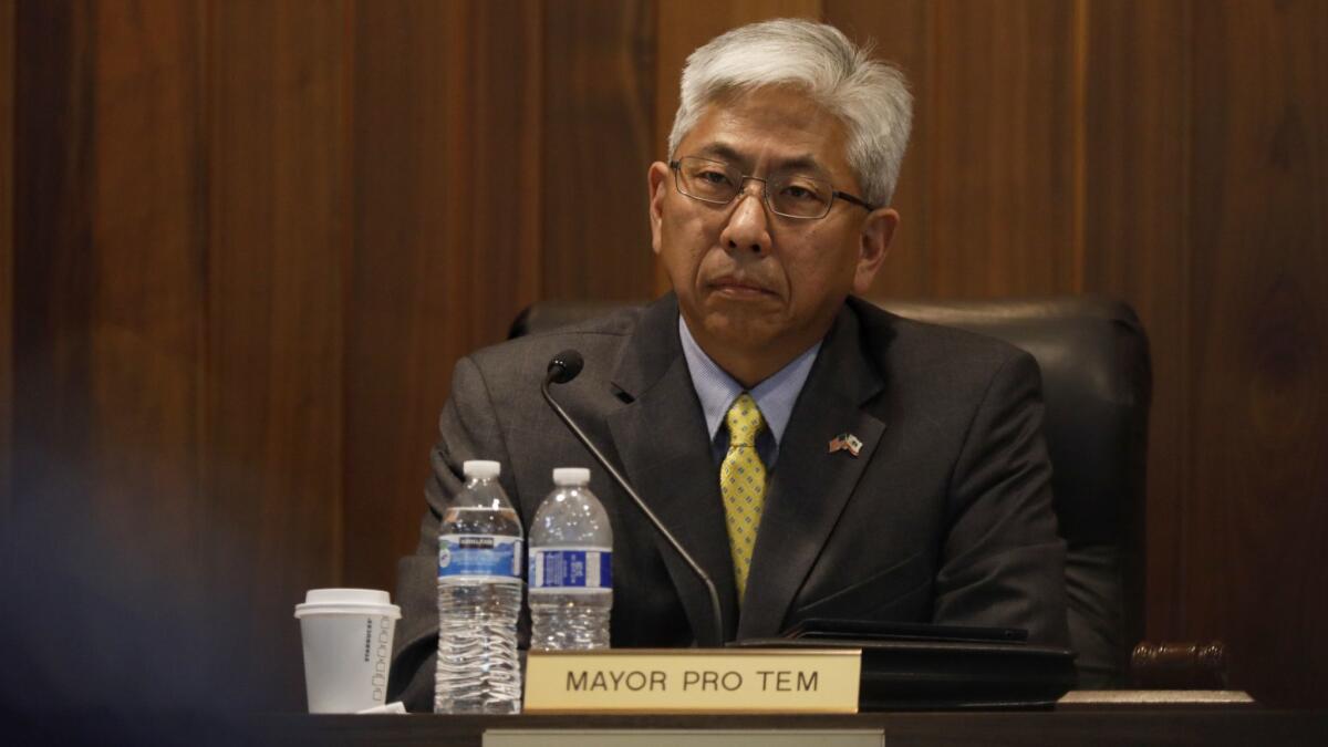 Los Alamitos Mayor Pro Tem Warren Kusumoto listens during public comments at a council meeting last month. He's been invited to meet with President Trump in the White House about immigration.