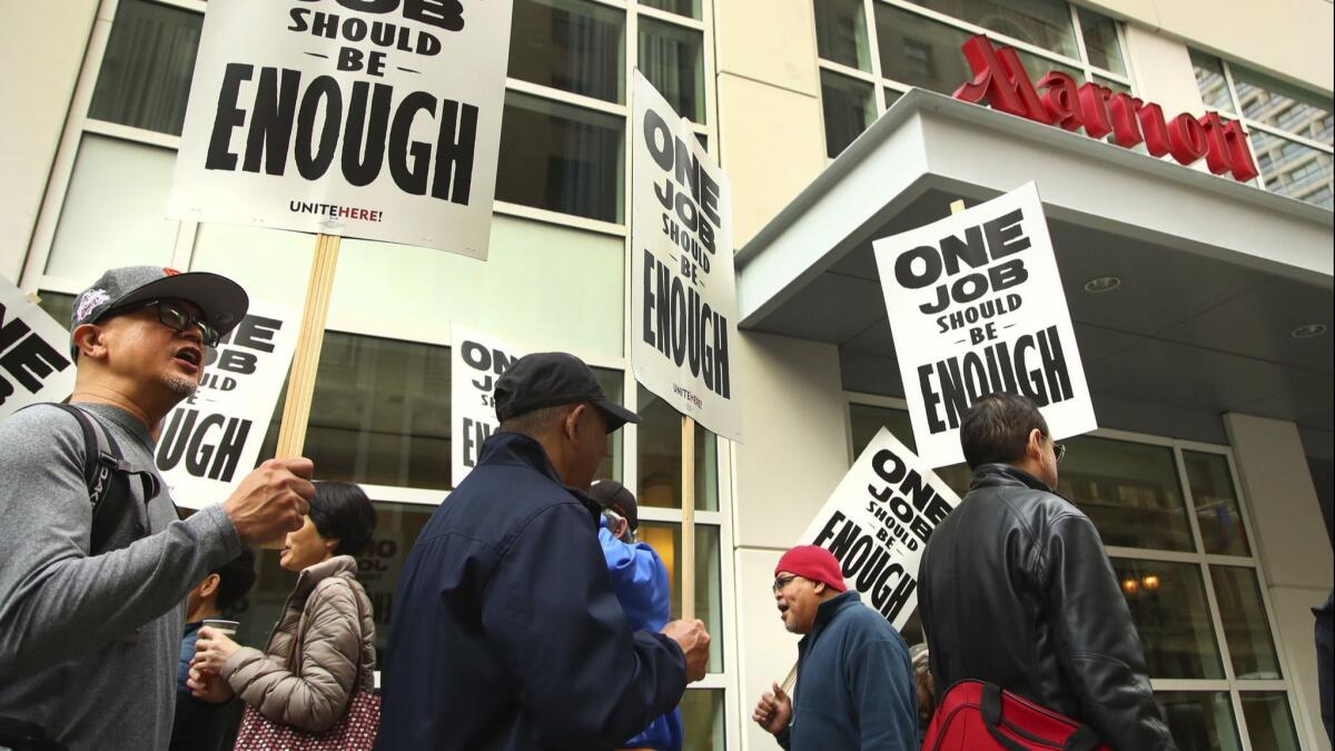 Hotel workers picket in front of a Marriott hotel in San Francisco during the strike there, which was settled in early December. Now two dozen Southern California hotels face the possibility of a strike as early as Wednesday.