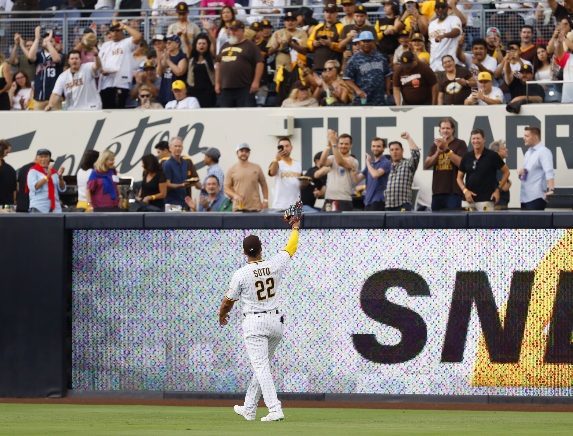 Padres right fielder Juan Soto waves to the crowd at the start of a game against the Rockies at Petco Park on Wednesday.