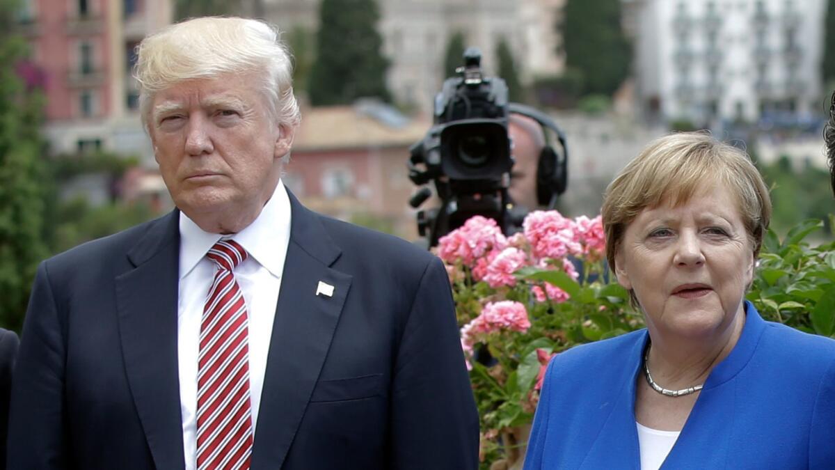 President Trump is flanked by German Chancellor Angela Merkel during the G7 meeting in Taormina, Italy, on May 26.