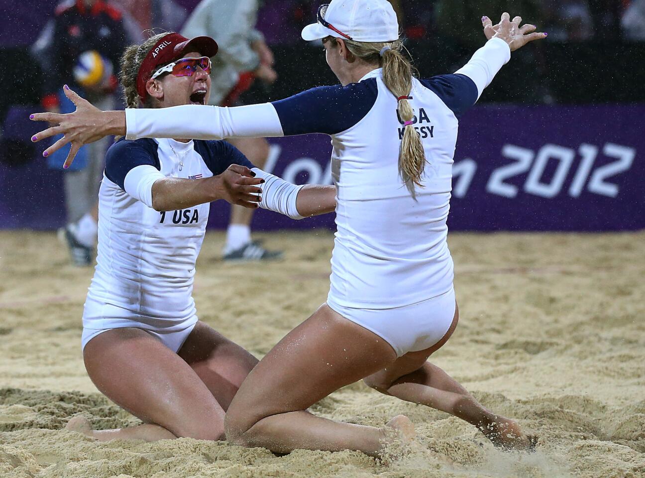 United States teammates Jennifer Kessy, right, and April Ross embrace after defeating top-seeded Brazil to move on to the women's beach volleyball finals against another American team.