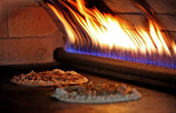 Manakeesh -- pizza-like flatbreads -- cook in the brick oven at Zait & Za'atar.