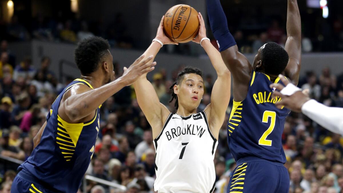 Nets guard Jeremy Lin (7) makes a pass between Pacers forward Thaddeus Young (21) and guard Darren Collison (2) during the second half Wednesday.