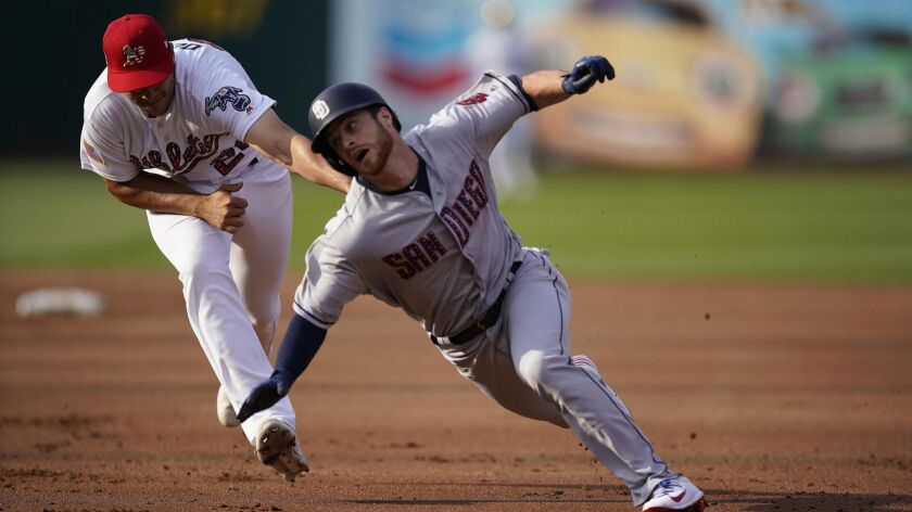 Cory Spangenberg is tagged out trying to by A's first baseman Matt Olson on July 3.