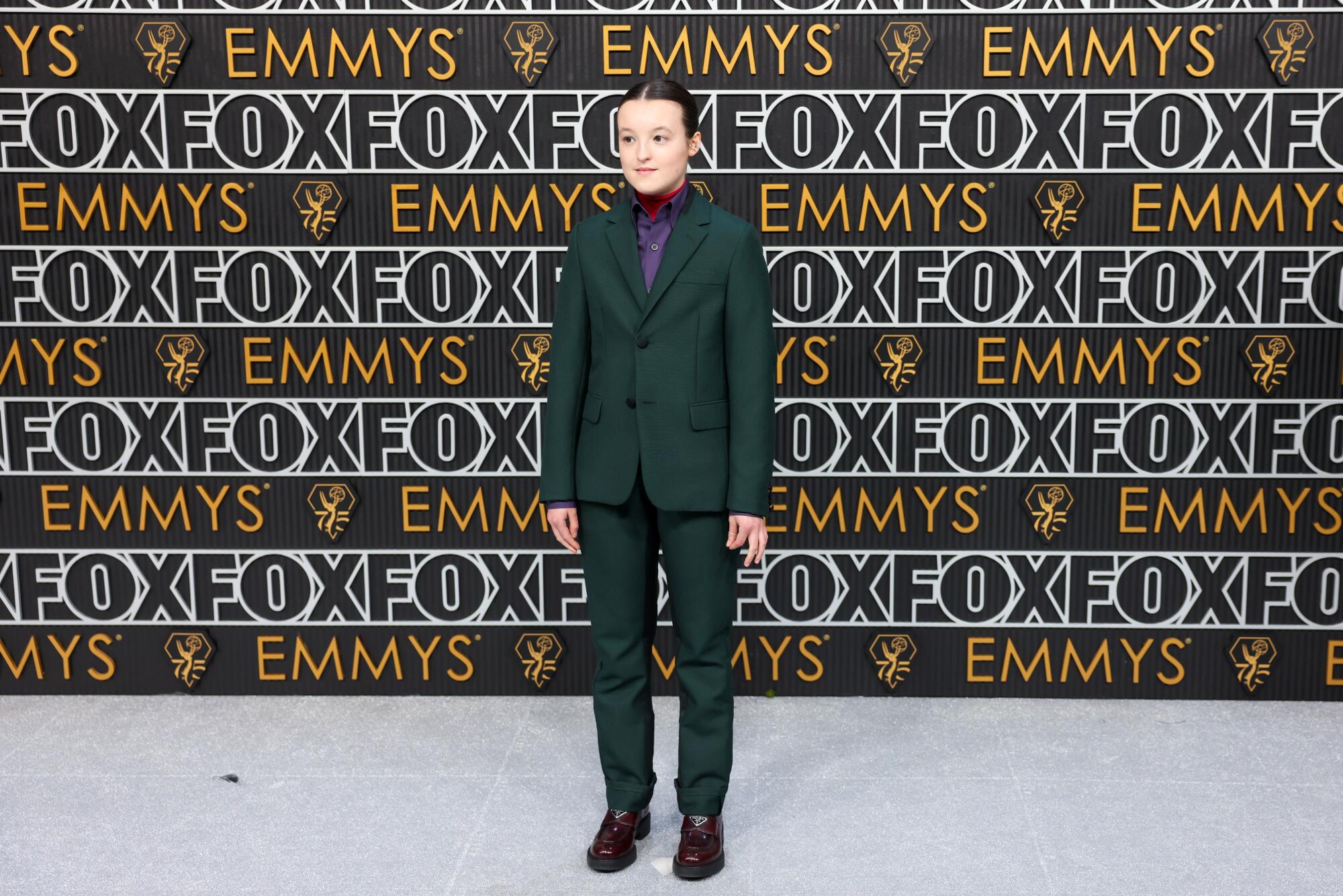 Bella Ramsey wears a green Prada suit on the Emmys red carpet. 