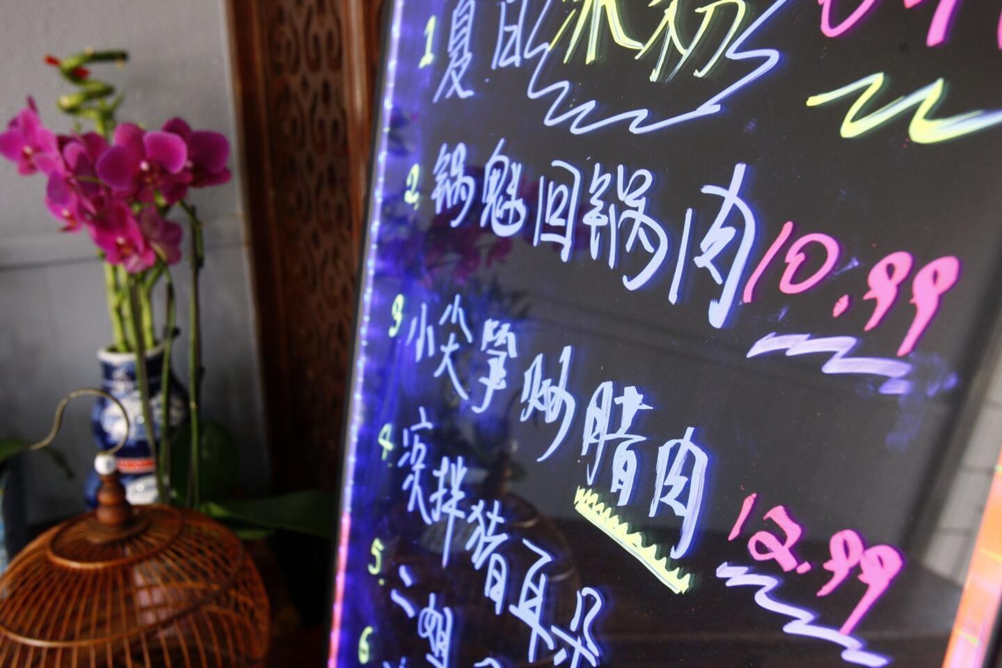Daily delicacies are listed on a board at the entrance to Chengdu Taste in Alhambra.
