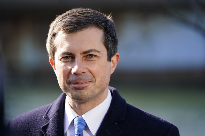 FILE - Transportation Secretary Pete Buttigieg listens at an event in Philadelphia, on Jan. 14, 2022. Buttigieg is launching a $1 billion pilot program aimed at helping reconnect cities and neighborhoods racially segregated or divided by road projects. He promises wide-ranging help to dozens of communities despite the program's limited dollars. (AP Photo/Matt Rourke, File)