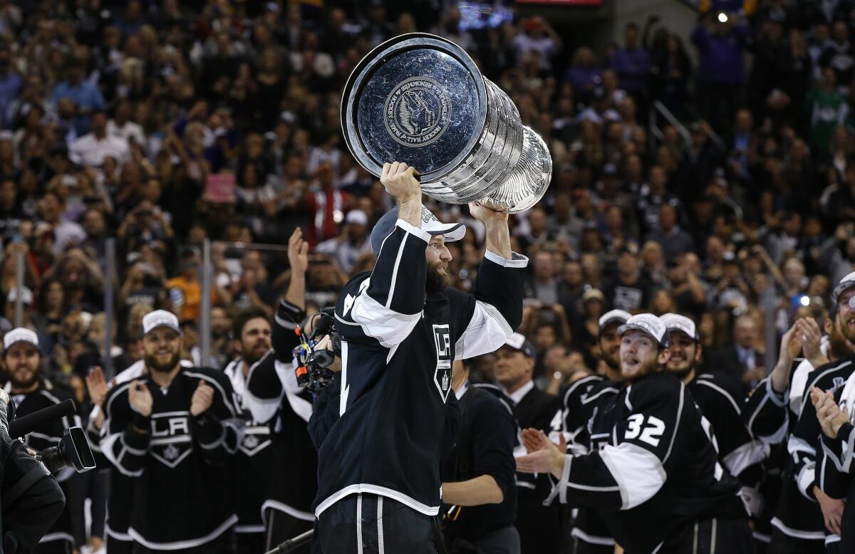 Defenseman Robyn Regehr holds the Stanley Cup above his head after the Kings' double-overtime victory over the New York Rangers that clinched the NHL championship in 2014.