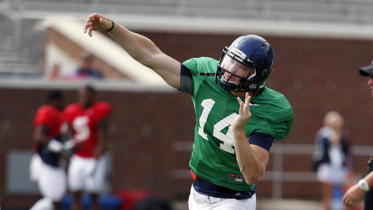 Mississippi quarterback Bo Wallace passes during a training camp session on Saturday. Wallace, who enters third season as a starter, has put up some impressive numbers while with the Rebels.