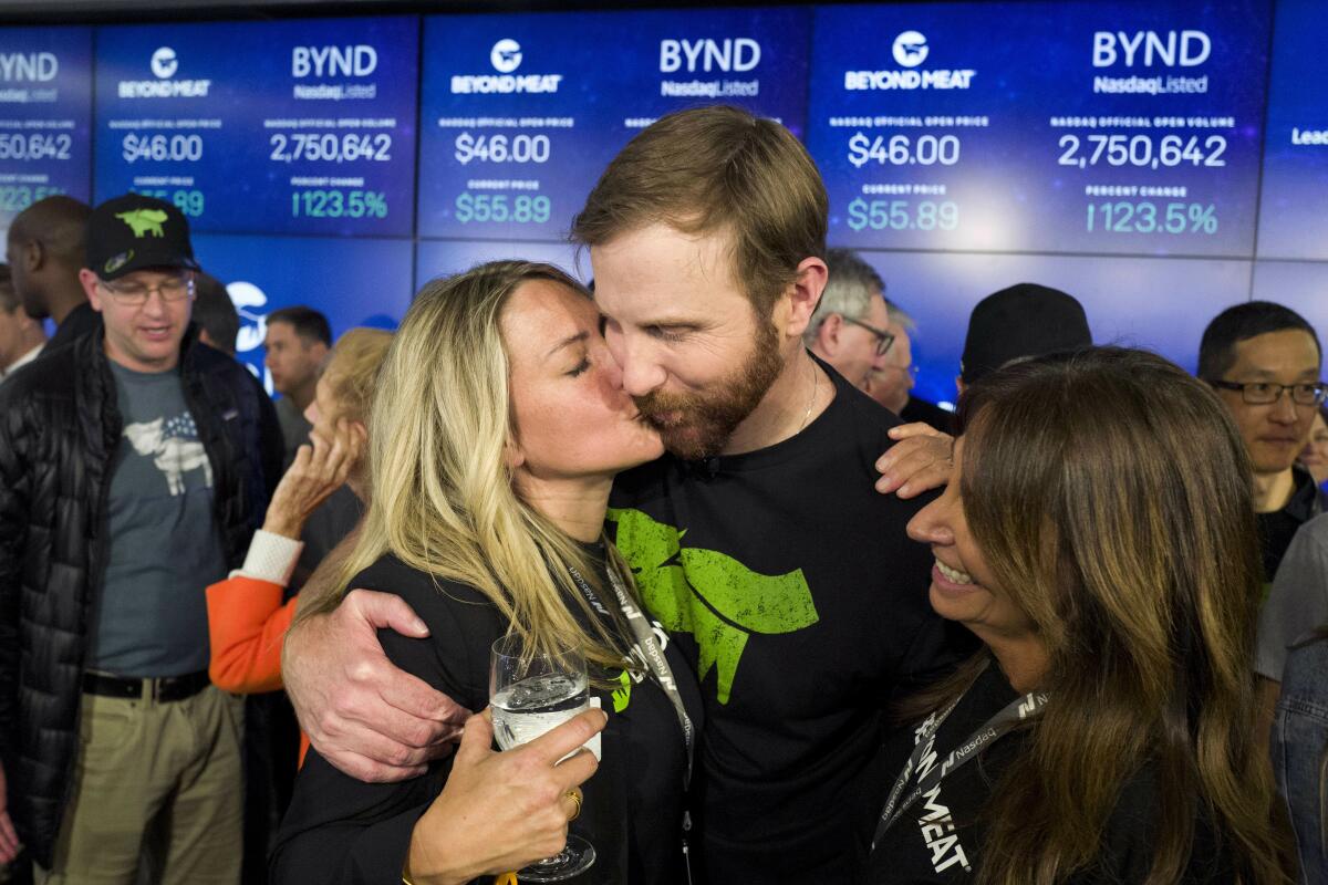 Tracy Brown kisses her husband, Ethan Brown, at the Nasdaq stock exchange
