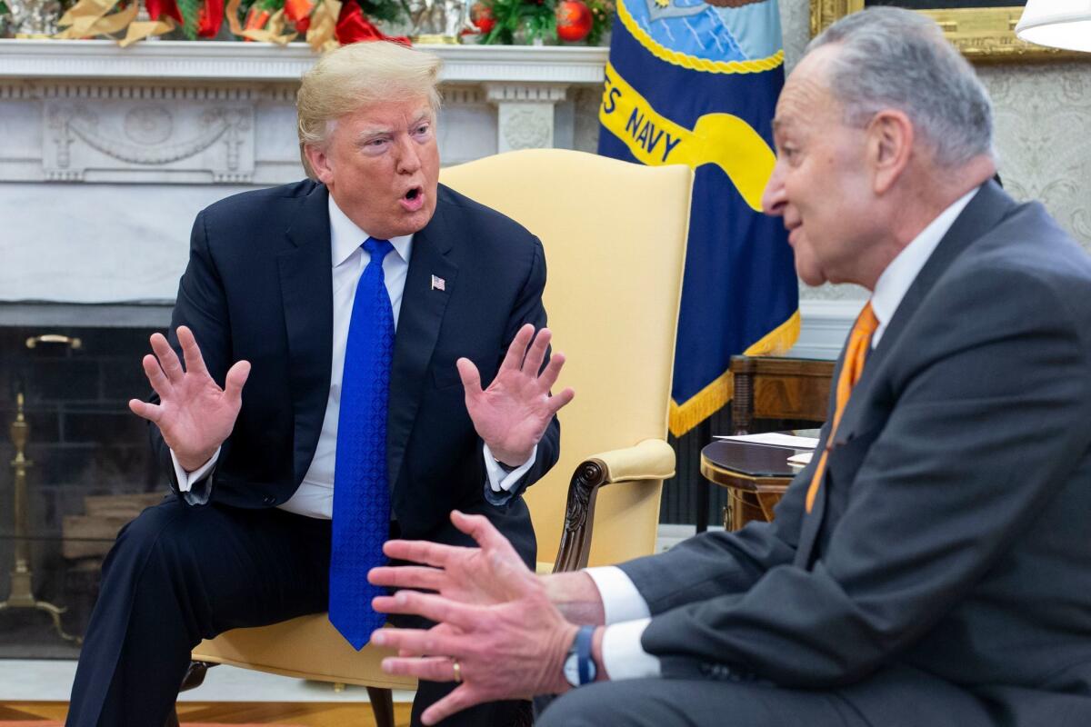 President Trump and Senate Minority Leader Charles E. Schumer (D-N.Y.) exchange words during a meeting in the Oval Office on Tuesday.