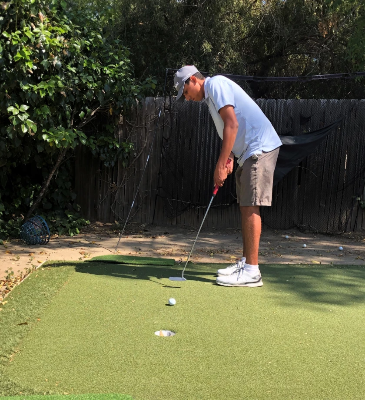 Ivan Barahona Jr. practices his putting at home.