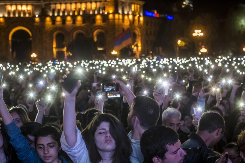 YEREVAN, ARMENIA MAY 7, 2018 -- People hold their cell phone flashlights overhead during a gathering on Republic Square to hear protest leader Nikol Pashinian address the crowd on the eve of his expected election as Prime Minister on Monday, May 7, 2018 in Yerevan, Armenia. (Brendan Hoffman / For The Times)