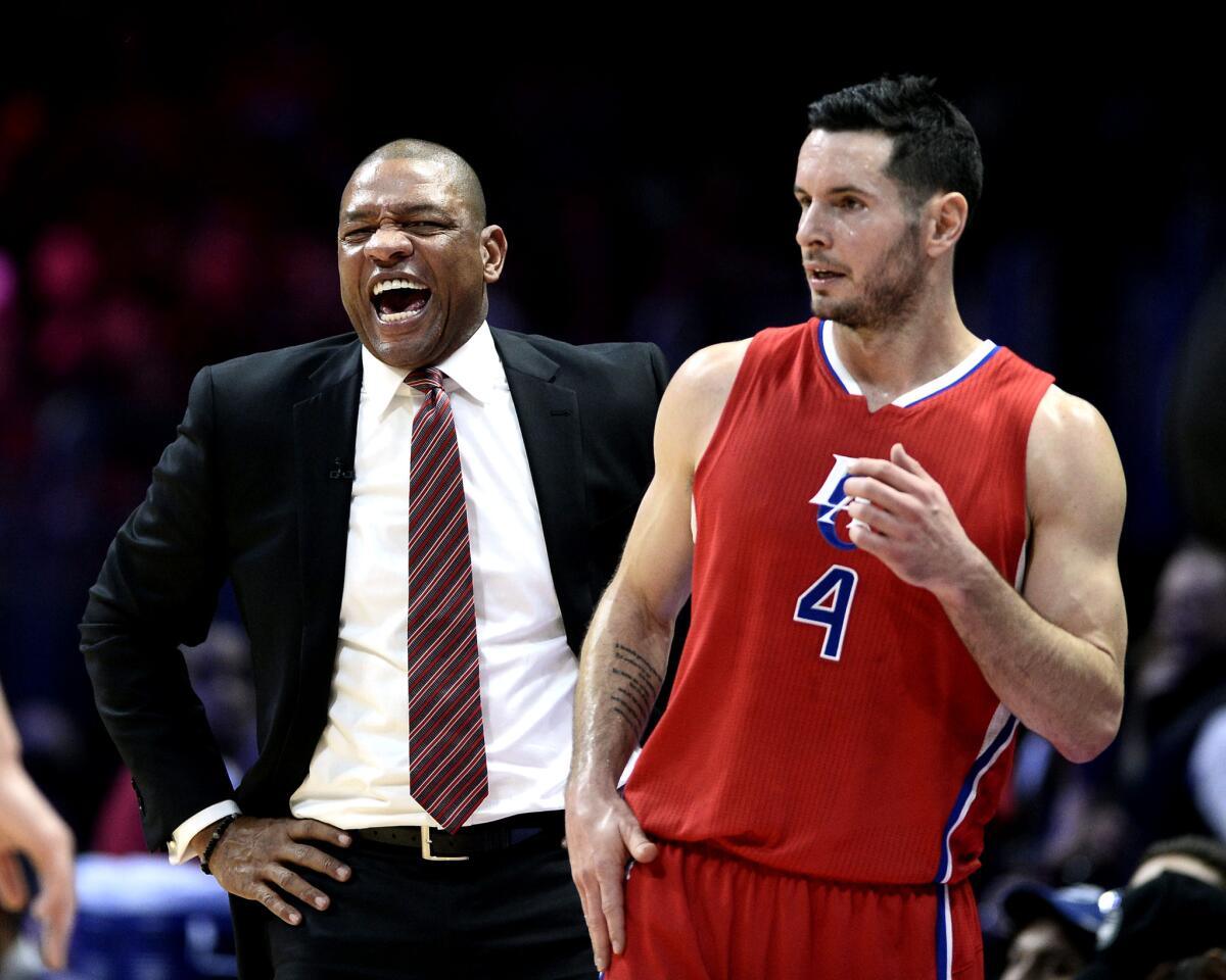 Coach Doc Rivers is all smiles as guard J.J. Redick and the Clippers finish off a 100-86 victory over the Warriors on Christmas at Staples Center.