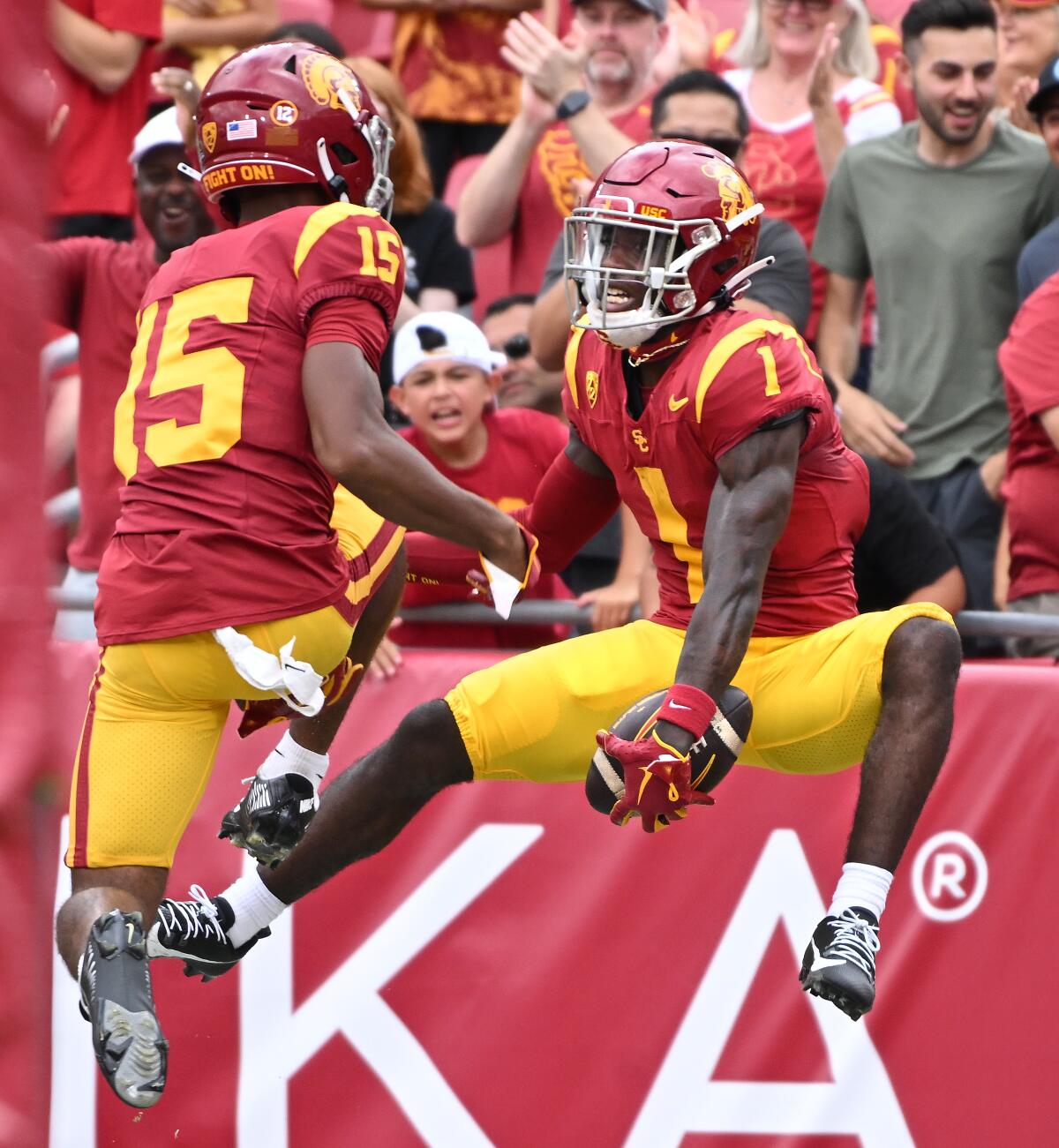 USC wide receiver Zachariah Branch celebrates with teammate Dorian Singer after making a touchdown catch.