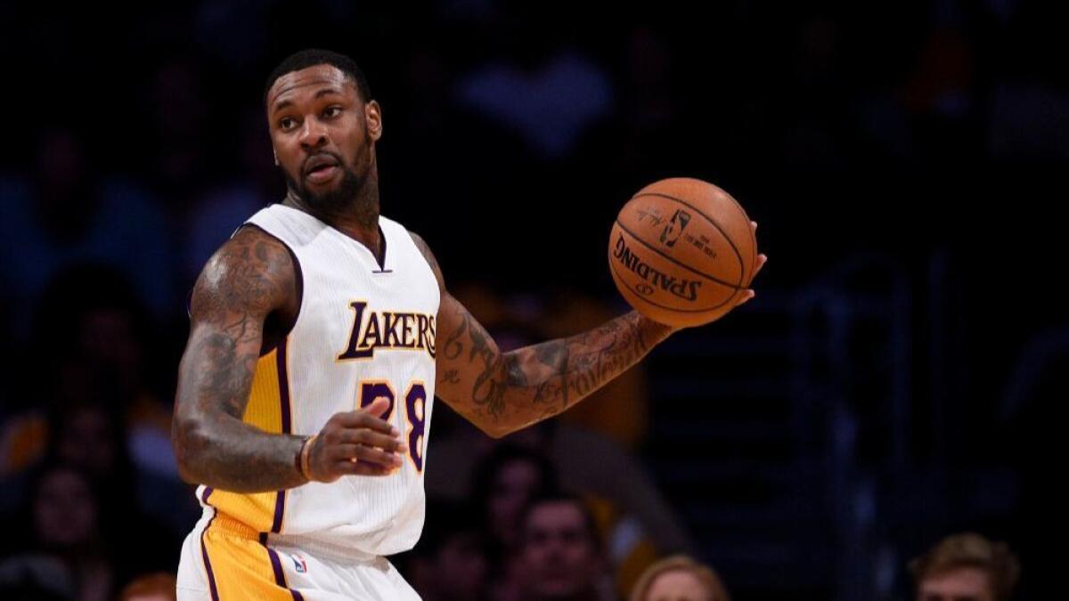 Lakers center Tarik Black looks to pass during the first half of a game against the Toronto Raptors on Jan. 1.