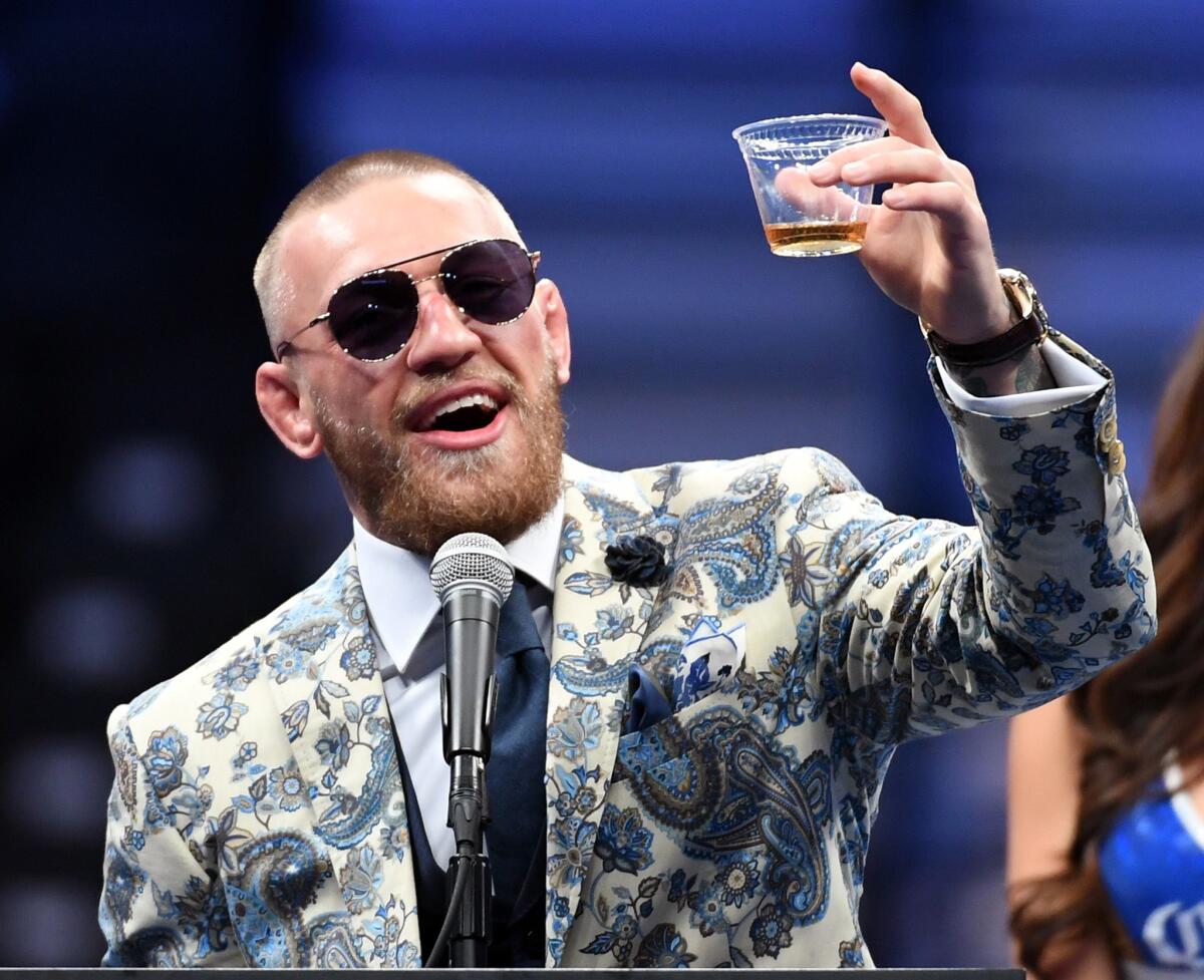 LAS VEGAS, NV - AUGUST 26: Conor McGregor holds up a drink as he speaks during a news conference after his 10th-round TKO loss to Floyd Mayweather Jr. in their super welterweight boxing match at T-Mobile Arena on August 26, 2017 in Las Vegas, Nevada.