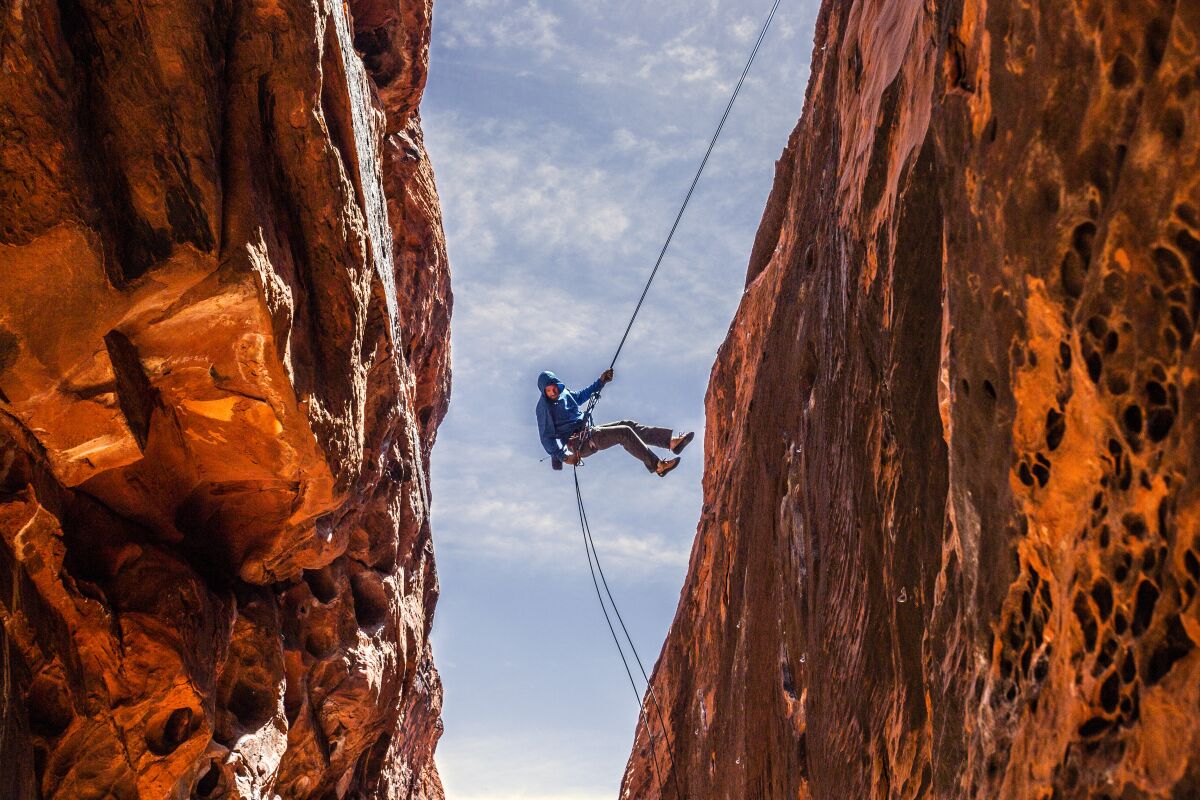 A rock climber descends into a slot canyon at Red Rock Canyon National Conservation Area near Las Vegas.