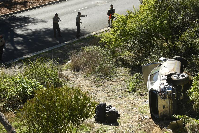 L.A. County Sheriff's officers investigate an accident involving golfer Tiger Woods along Hawthorne Blvd. 
