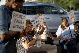 MURRIETA, CA - AUGUST 10, 2023: In an overflow parking lot area, supporters of the parental notification policy hold up signs stating "Protect Family Values" during a school board meeting which decided 3-2 to enact a policy which would notify parents if any child identifies as transgender in schools on August 10, 2023 in Murrieta, CA. (Gina Ferazzi / Los Angeles Times)