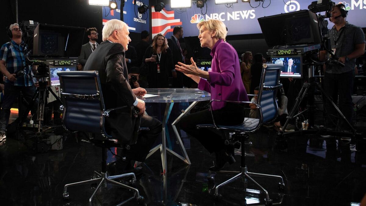Democratic presidential hopeful Elizabeth Warren speaks with NBC anchor Chris Matthews after participating in the first Democratic primary debate of the 2020 presidential campaign season.
