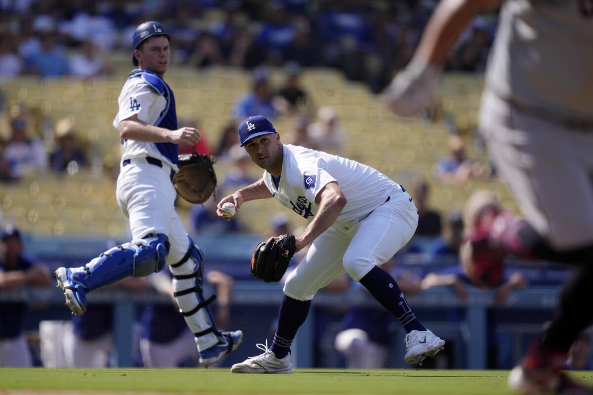 Dodgers starting pitcher Jack Flaherty, center, throws out Cleveland's Josh Naylor at first base at Dodger Stadium.