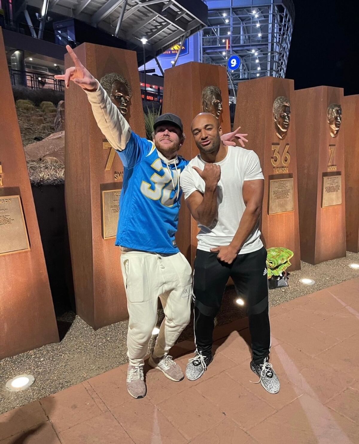 Brothers Wyett (left) and Austin Ekeler outside the Denver Broncos' Empower Field at Mile High in the 2021 season.