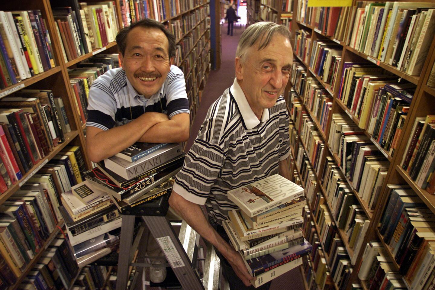 Brand Bookshop owner Jerome Joseph, right, and longtime manager Noriaki Nakano in the shop in 2003.